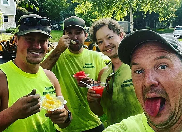 Asphalt Driveway Co. crew in hi-vis shirts