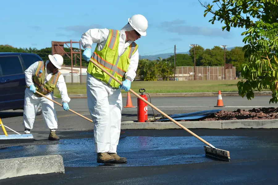 Crew applying sealer to a commercial parking lot