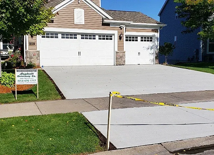 Finished concrete driveway with the company yard sign