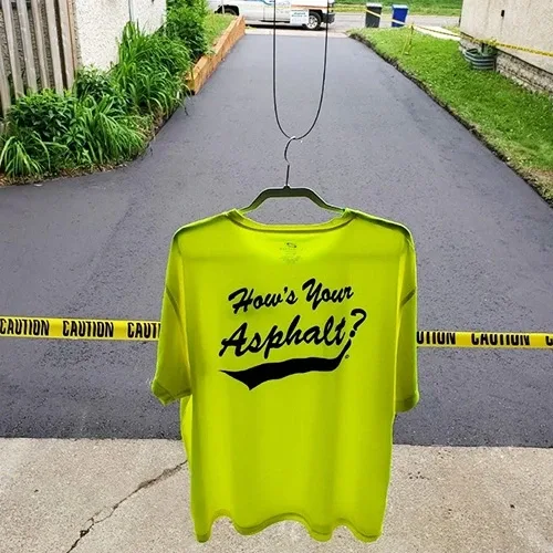 Shirt that says "How's your asphalt?" with an asphalt driveway in the background
