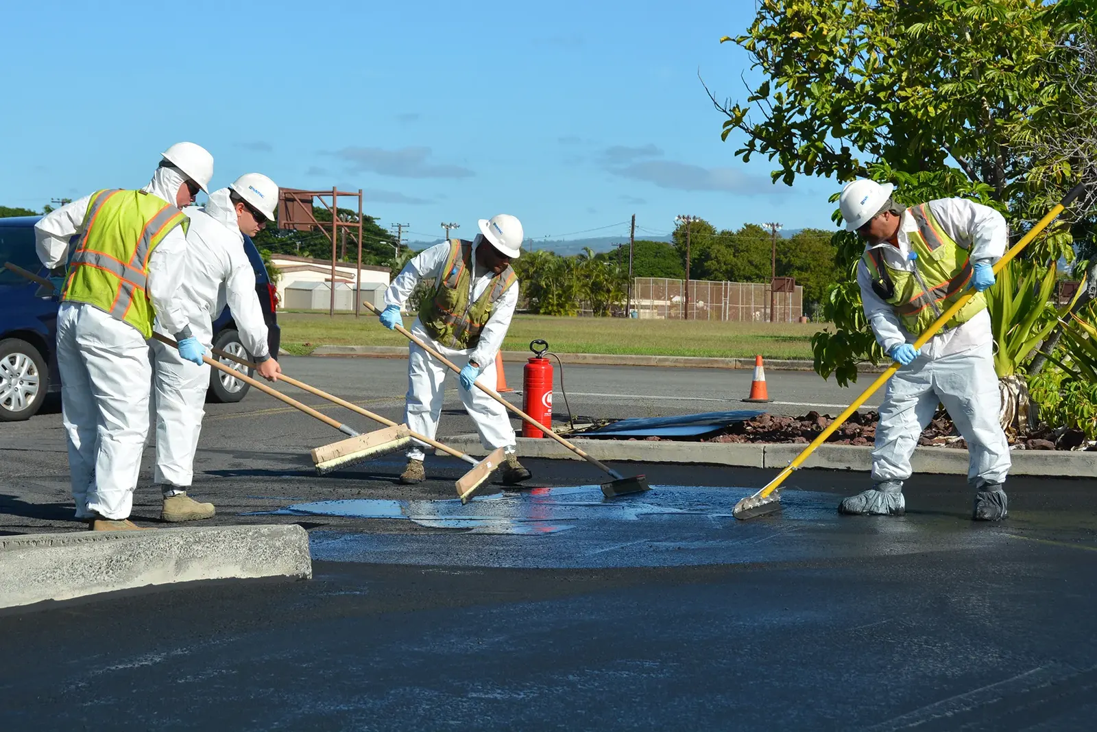 Crew seal coating a commercial parking lot